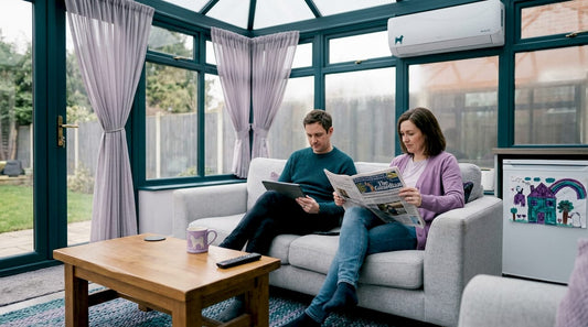 Couple relaxing near air conditioning in UK home
