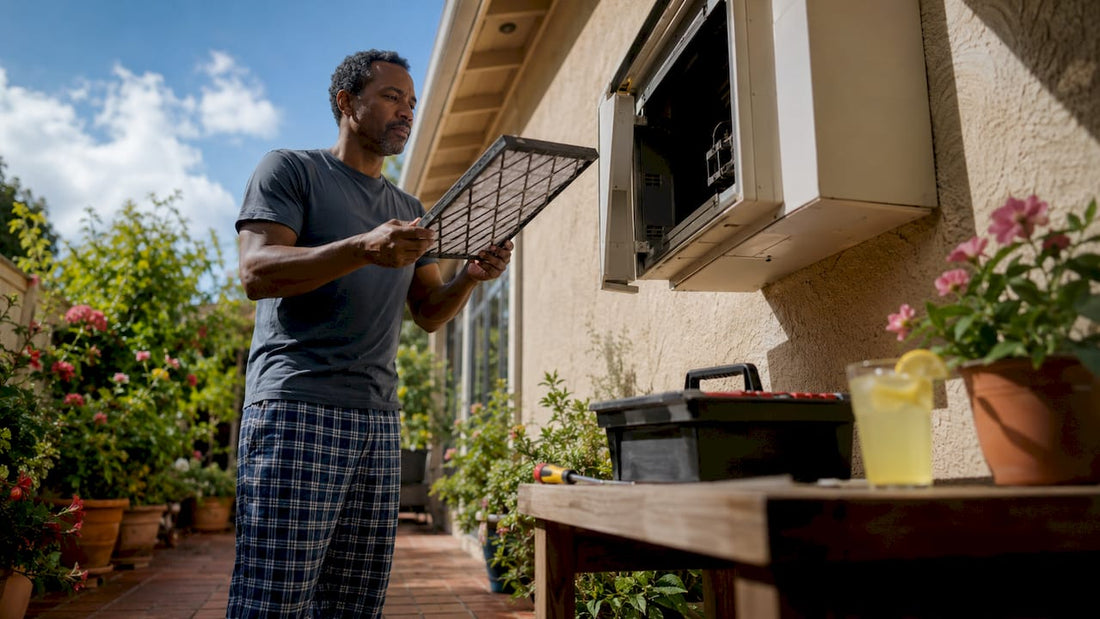 Homeowner inspecting HVAC air filter in basement