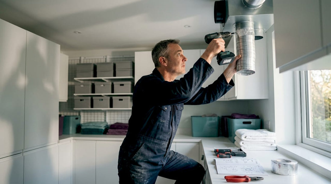 HVAC technician installing ventilation unit indoors