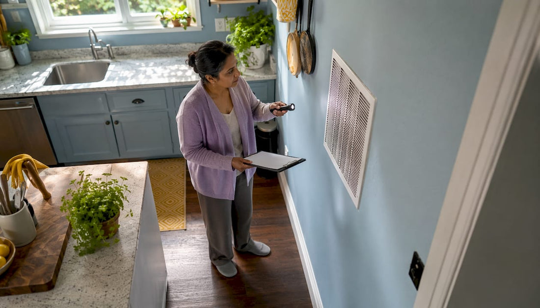 Homeowner inspecting HVAC air return grille