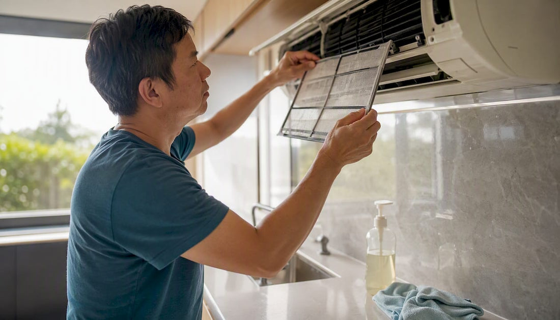 Homeowner cleaning aircon filter at home