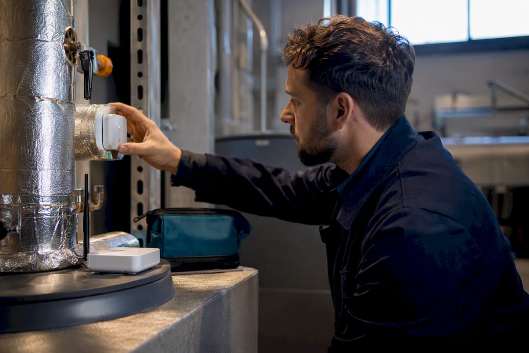 Technician checking HVAC monitoring sensor
