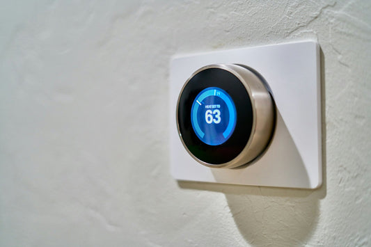 Smart thermostat on a wall controlling indoor air conditioning temperature