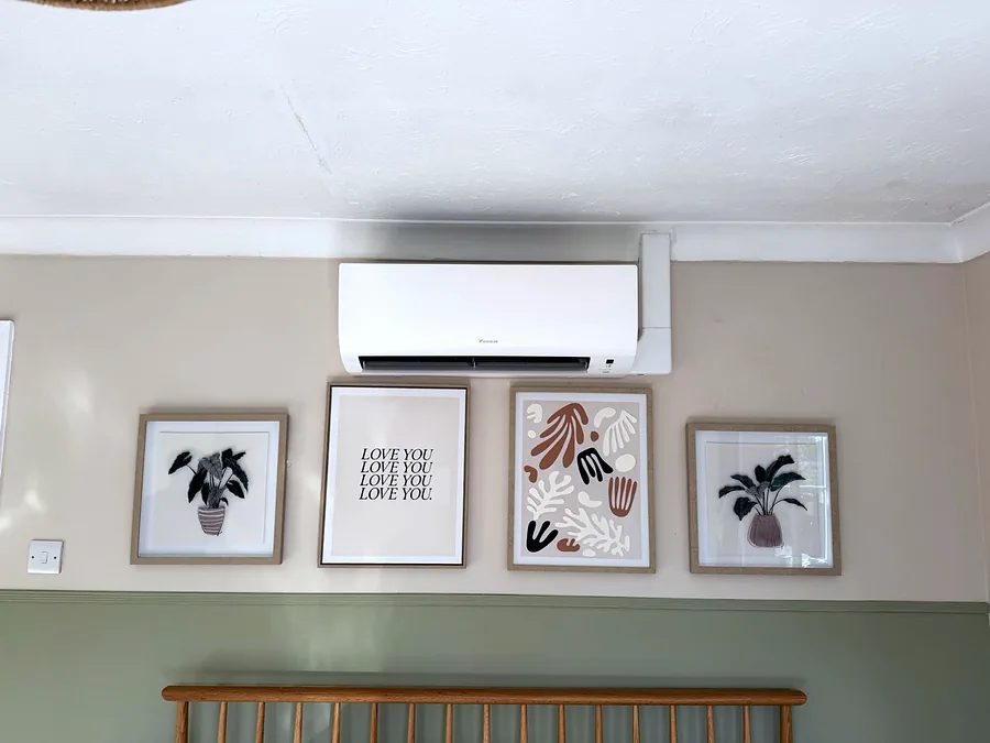 A Daikin wall unit we installed above framed artwork in a living room